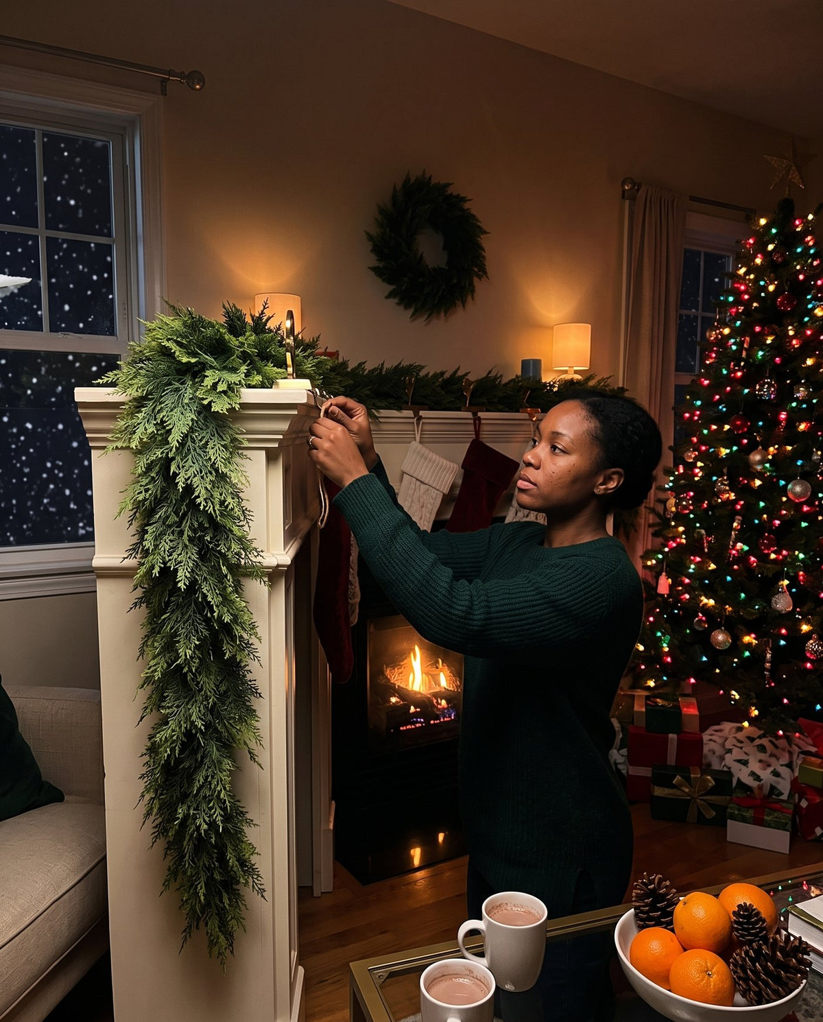The Hearthside real-touch cedar garland — hooking it on the mantel
